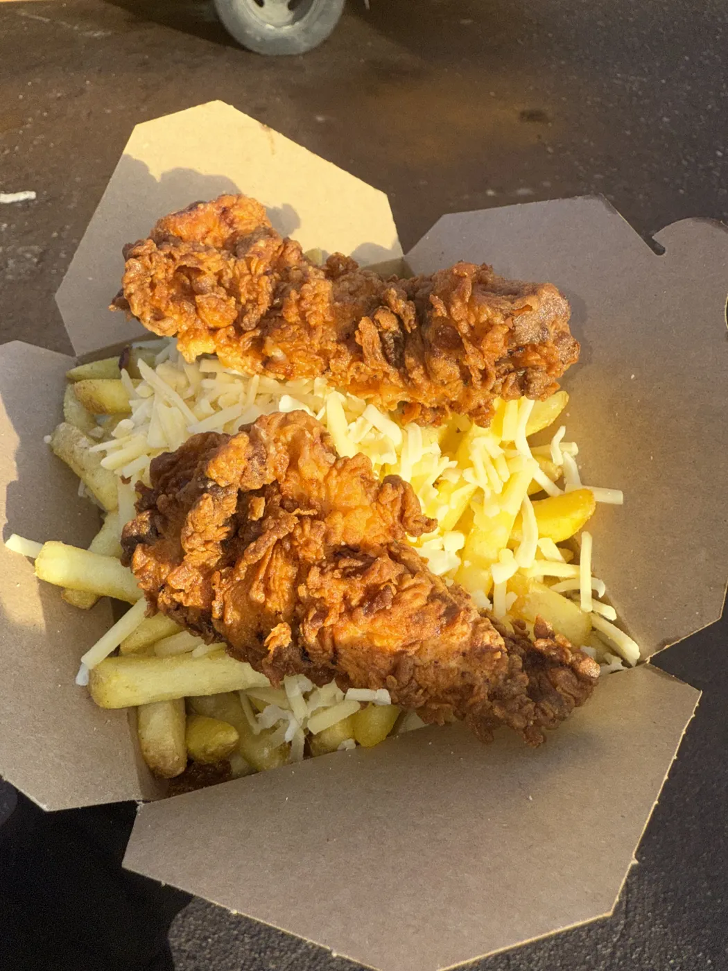 Chips topped with cheese and buttermilk chicken strips